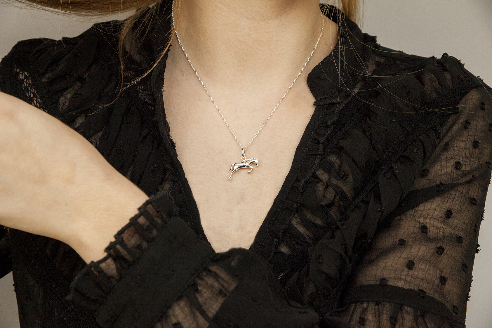 lady wearing horse necklace